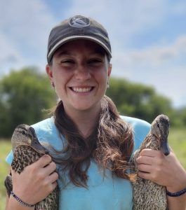 Kelsie Huss holding two mallards